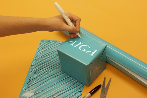 Image of a wrapped gift with AIGA logo