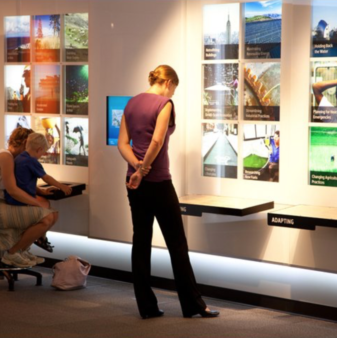Image of woman reading at the Marian Koshland Science Museum of the National Academy of Sciences reading interpretive text in the Earth Lab exhibition