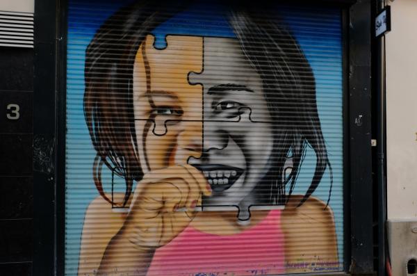 Photo of street art graffiti of young black girl in pink tank top. Photo by Boudewijn Huysmans on Unsplash