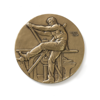 Front image of the AIGA Medal; Man manually operating a printing press